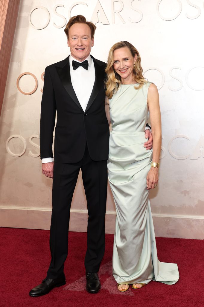 Conan O'Brien and Liza Powel O'Brien smile for cameras at the 97th Annual Academy Awards