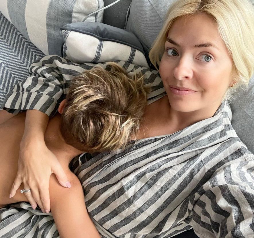 Young boy lying on Holly Willoughby
