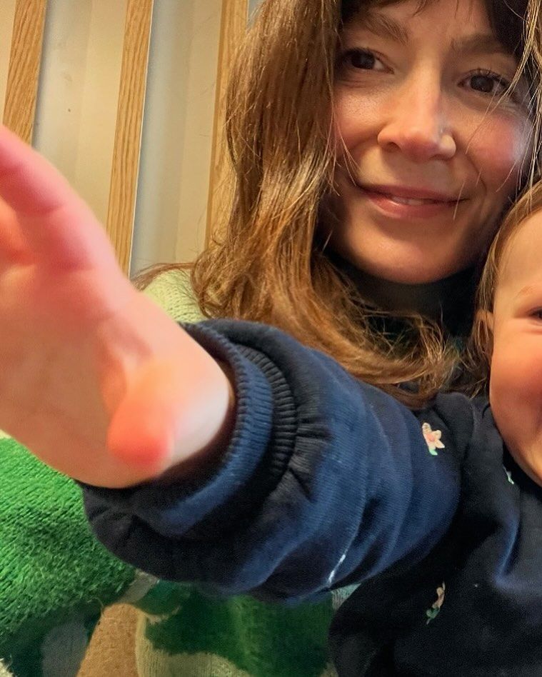 Natasha Raskin Sharp's daughter reaching toward the camera