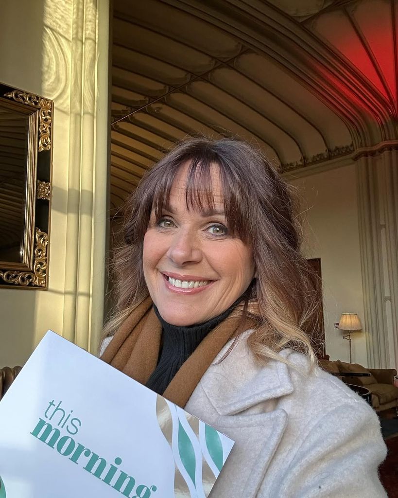 TV presenter smiling for selfie