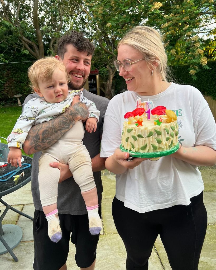 parents posing with son on first birthday