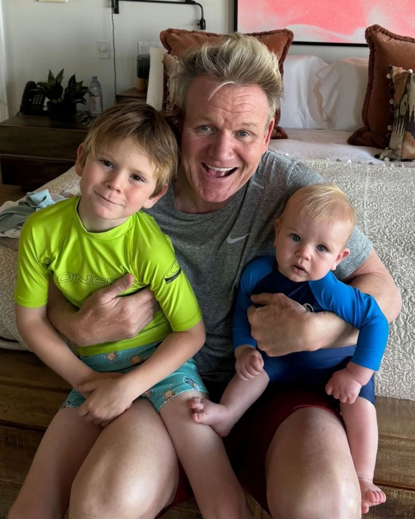 father posing for photo with two sons 