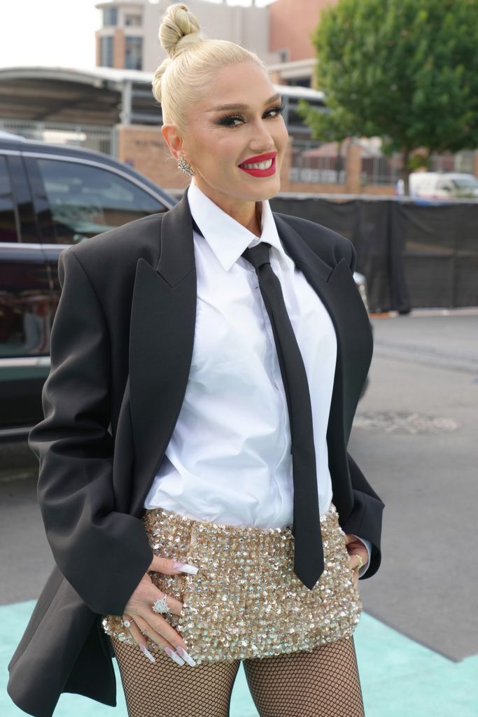 Gwen Stefani smiling for a photo at an event
