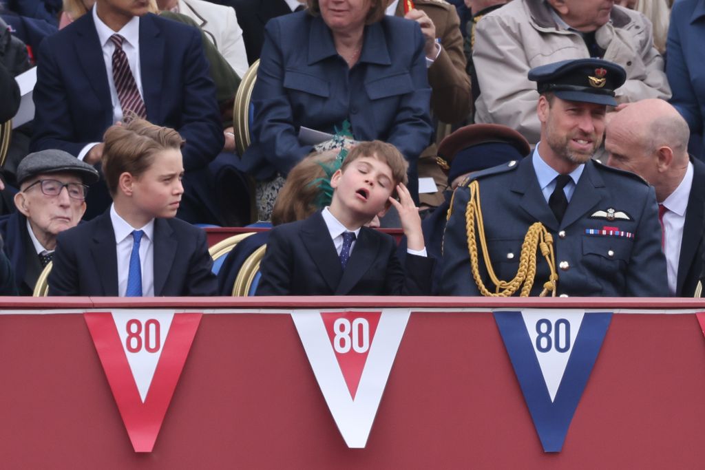 Prince Louis moving hair off face beside george and william
