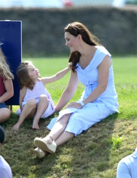 Kate Middleton and Princess Charlotte sat on grass verge