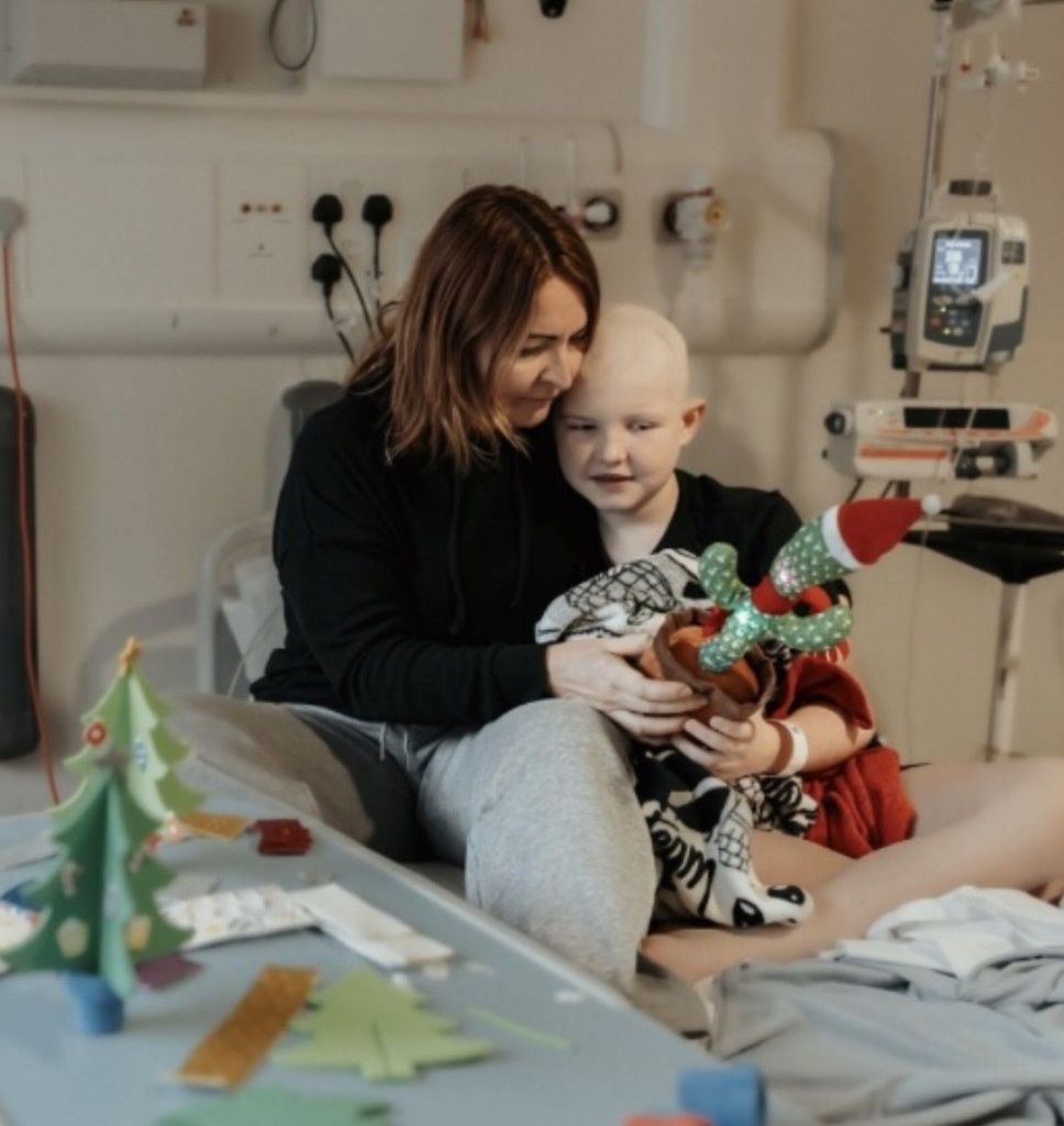 young boy with mum in hospital bed