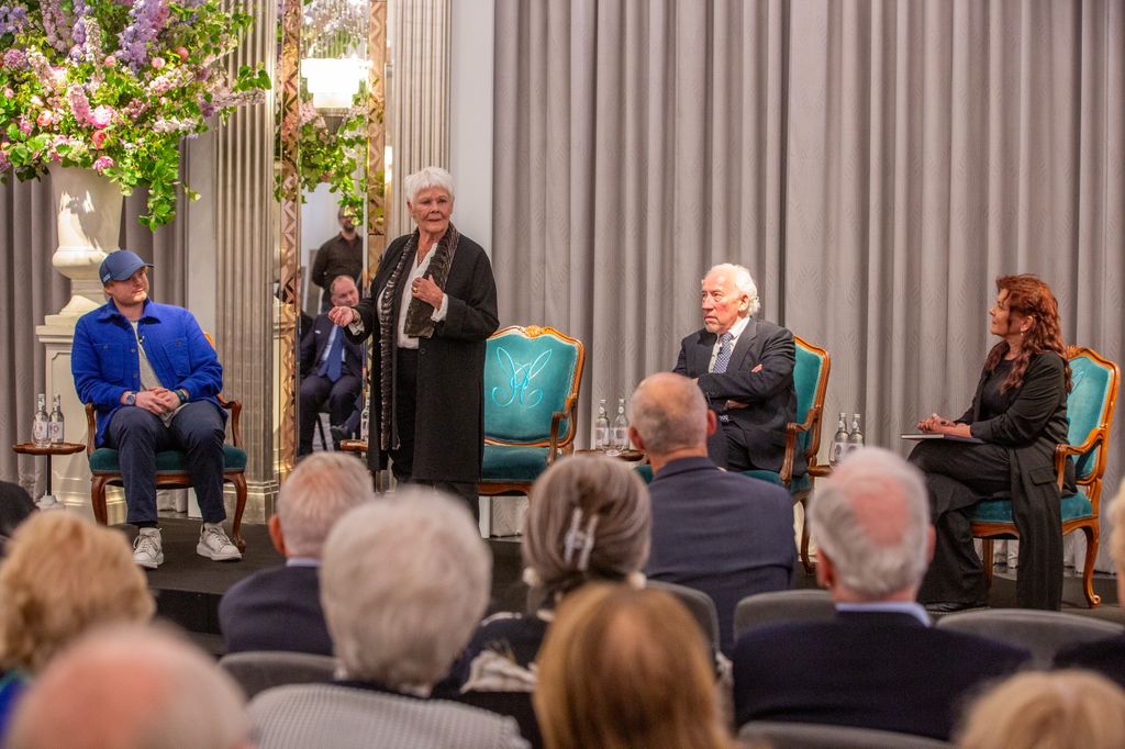 Dame Judi Dench speaking at a panel event with her daughter and grandson