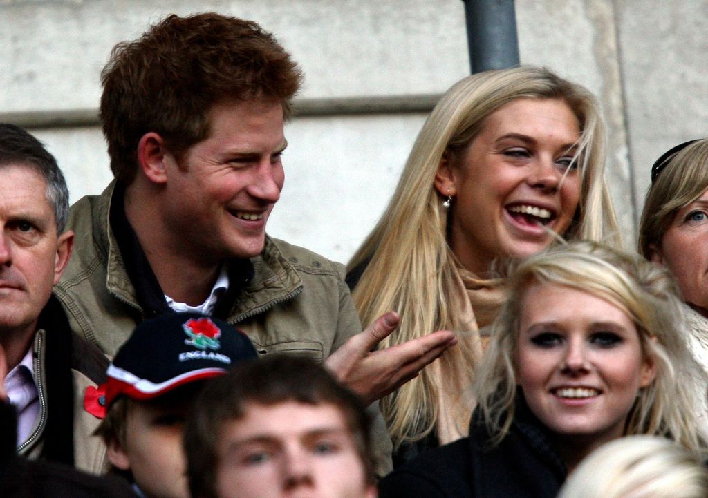 Prince Harry and Chelsy Davy sat smiling watching rugby together