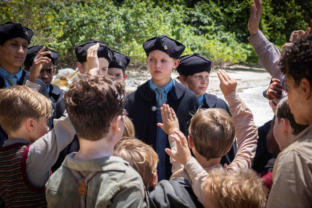 A group of boys with hands up