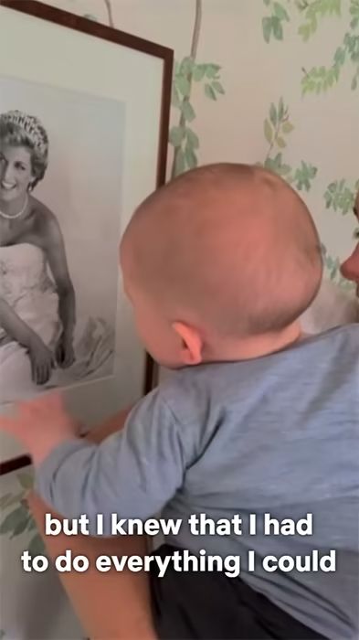 archie harrison looking at photo of princess diana