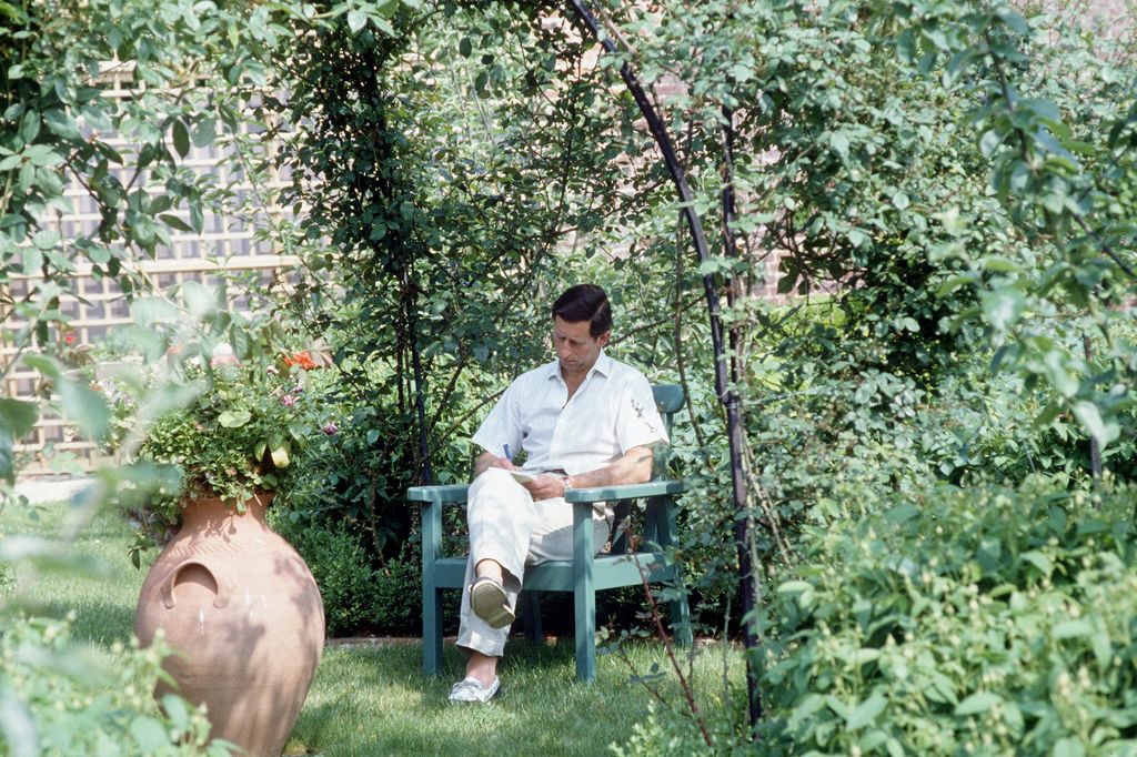 Prince Charles Writing In His Garden At Highgrove, Gloucestershire.