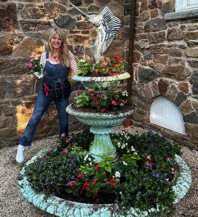 Christie Brinkley with fountain transformed into flowerpot