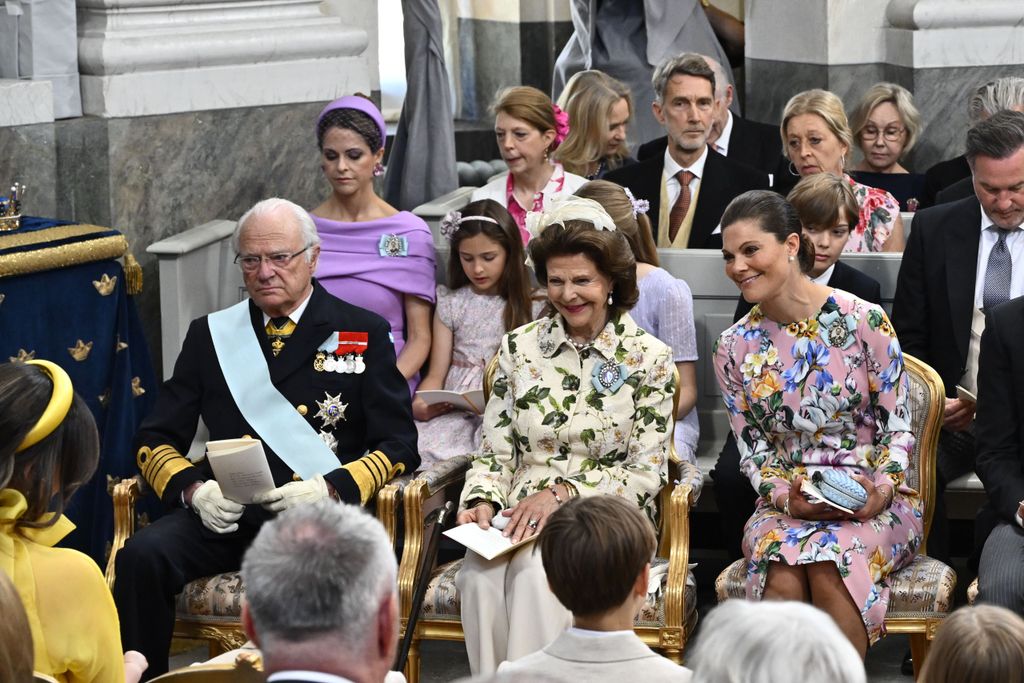 King Carl Gustaf, Queen Silvia, Crown Princess Victoria. Princess Madeleine and Chris O'Neill with children in the second row during Princess Ines' christening