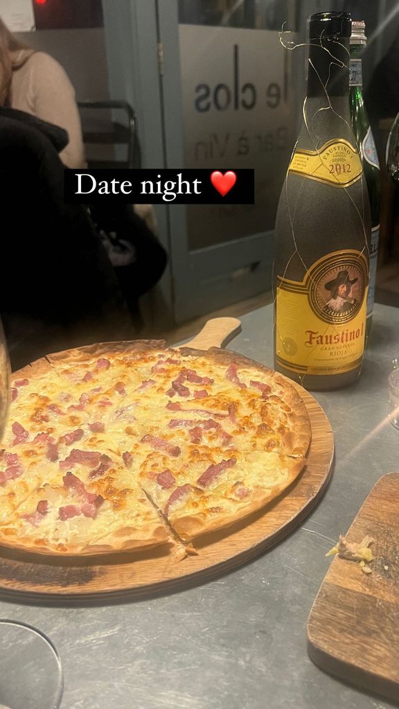 A photo of pizza and wine