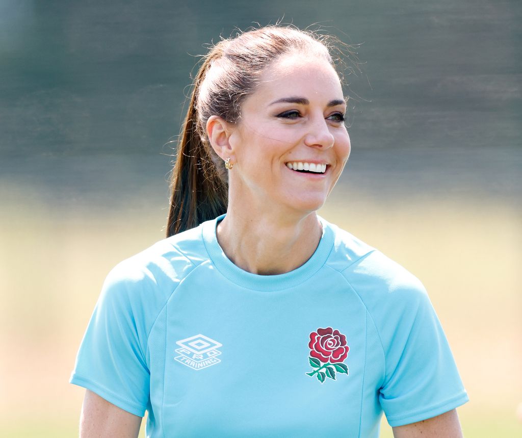 Kate Middleton smiling in blue rugby top