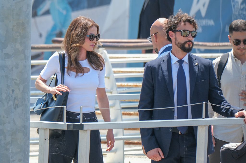 Queen Rania in group of people in white top and black trousers