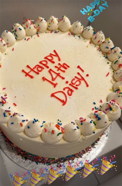 White cake that says happy 14th Daisy
