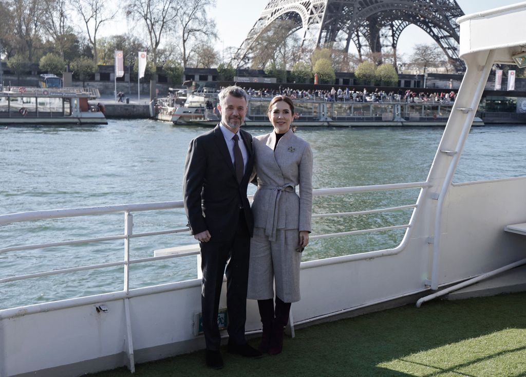 King Frederik and Queen Mary posing on a boat in front of the Eiffel Tower