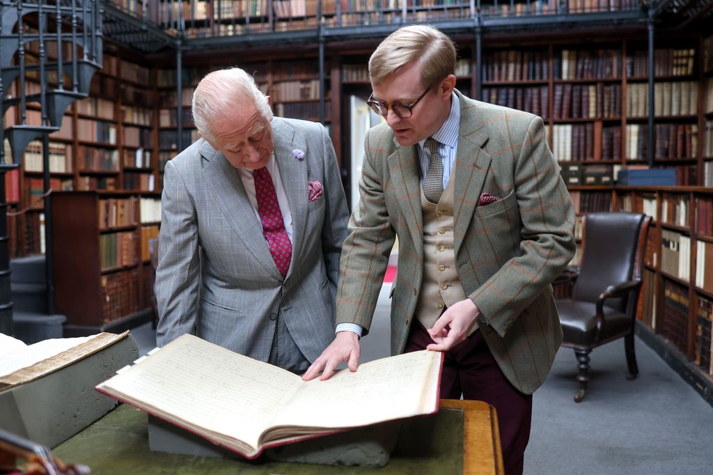 Daniel Joyce shows King Charles's historic items in the library