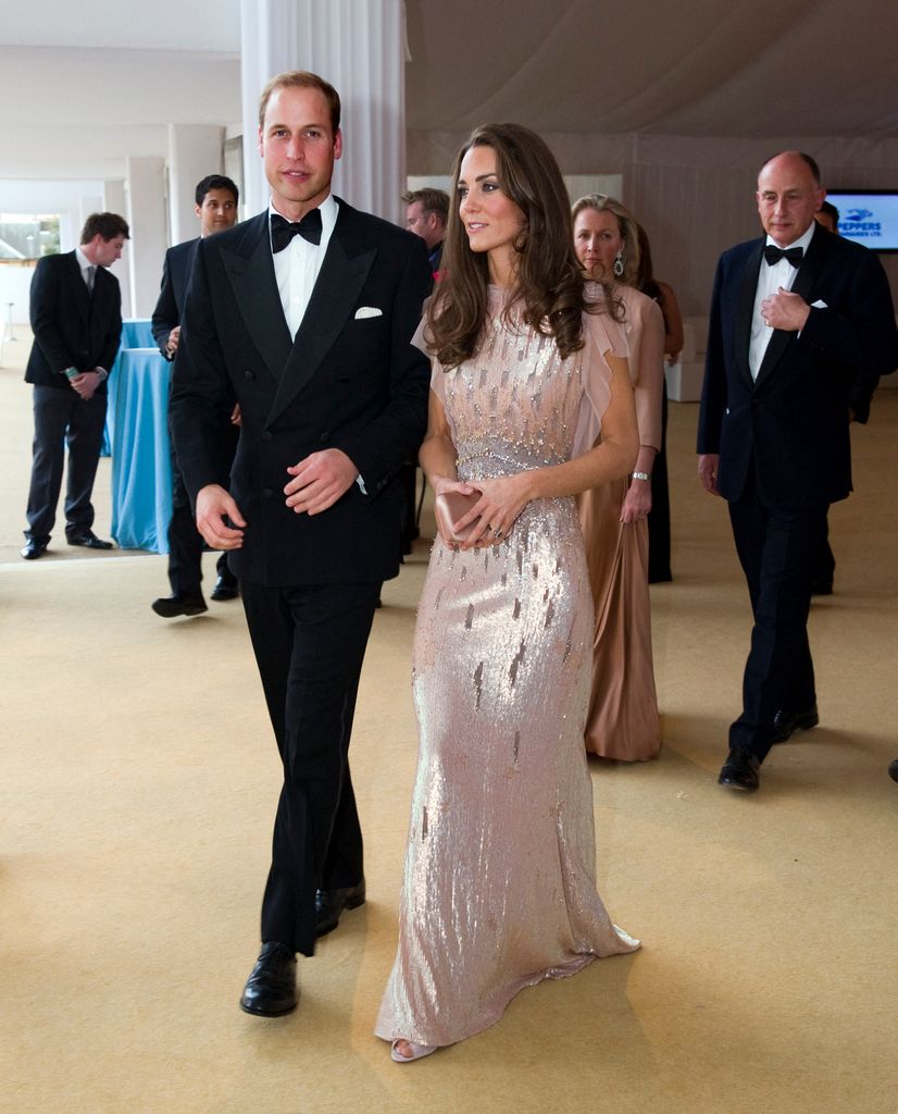 Kate in pale pink gown beside william in black tie