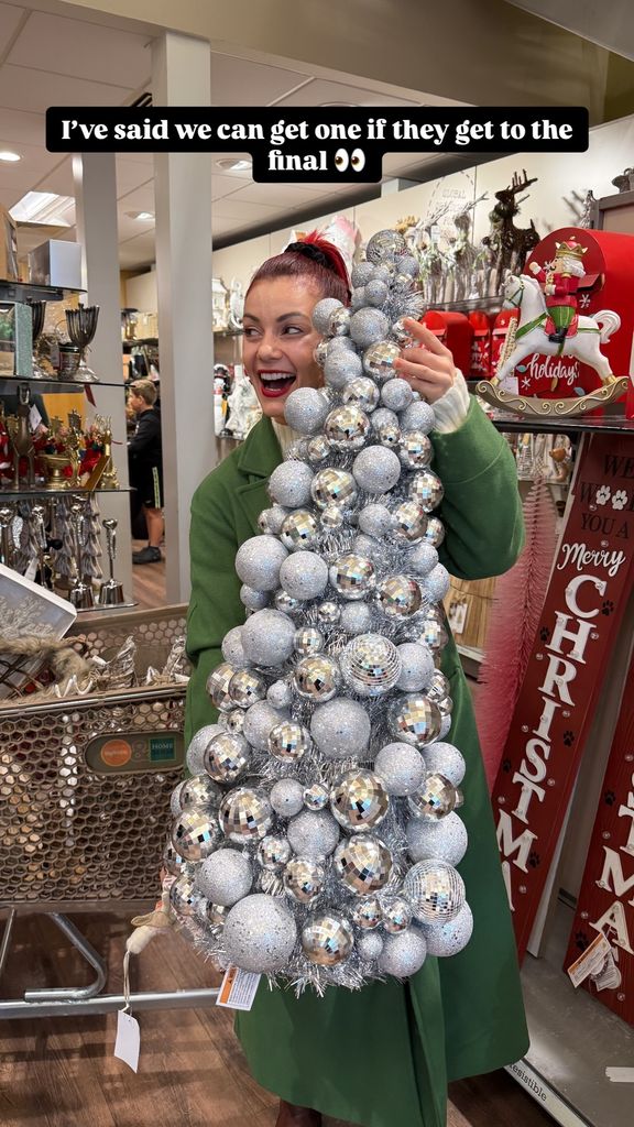 Dianne Buswell holding a glittering christmas tree