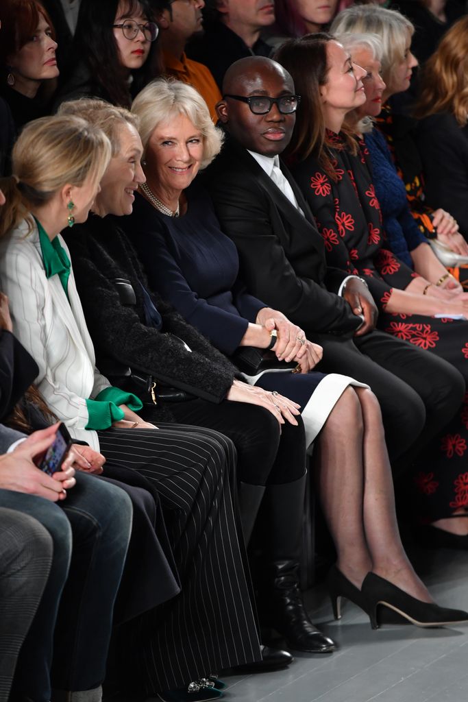 Camilla, Duchess Of Cornwall (C), Edward Enninful and Caroline Rush, Chief Executive of the British Fashion Council, attend the Bethany Williams show during London Fashion Week February 2019 at the BFC Show Space on February 19, 2019 in London, England.