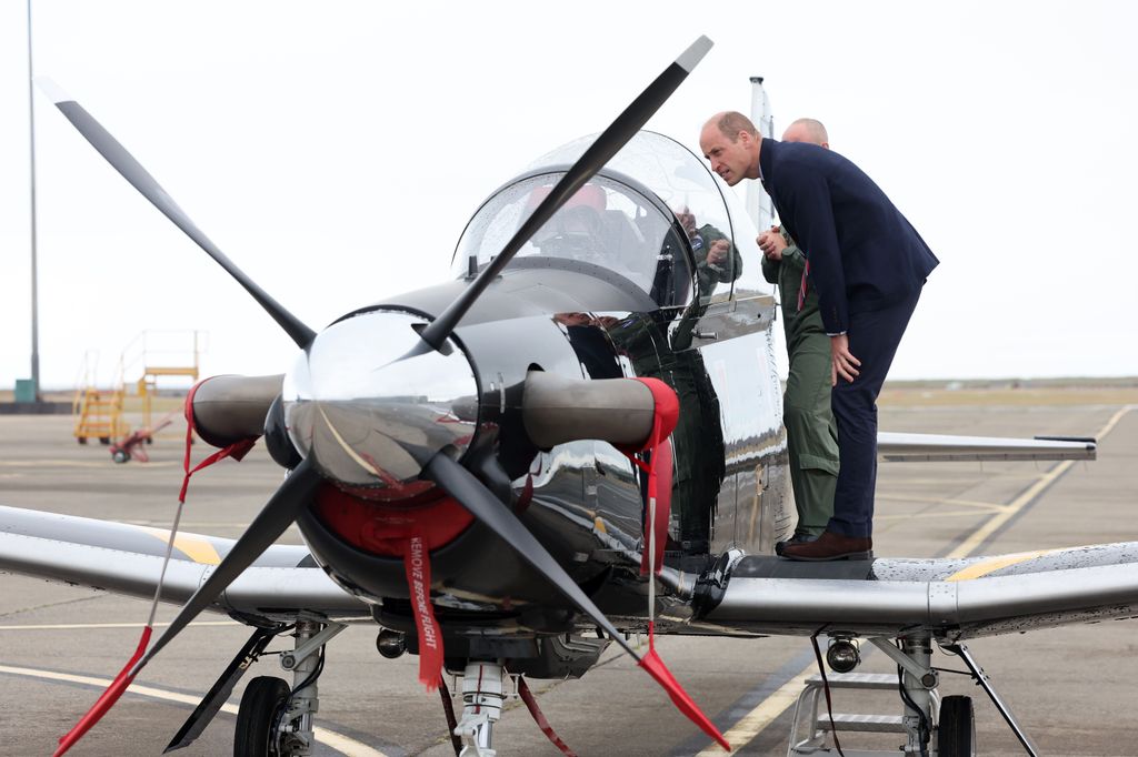 Prince William gets an introduction to a RAF Short Tucano trainer aircraft during an official visit at RAF Valley