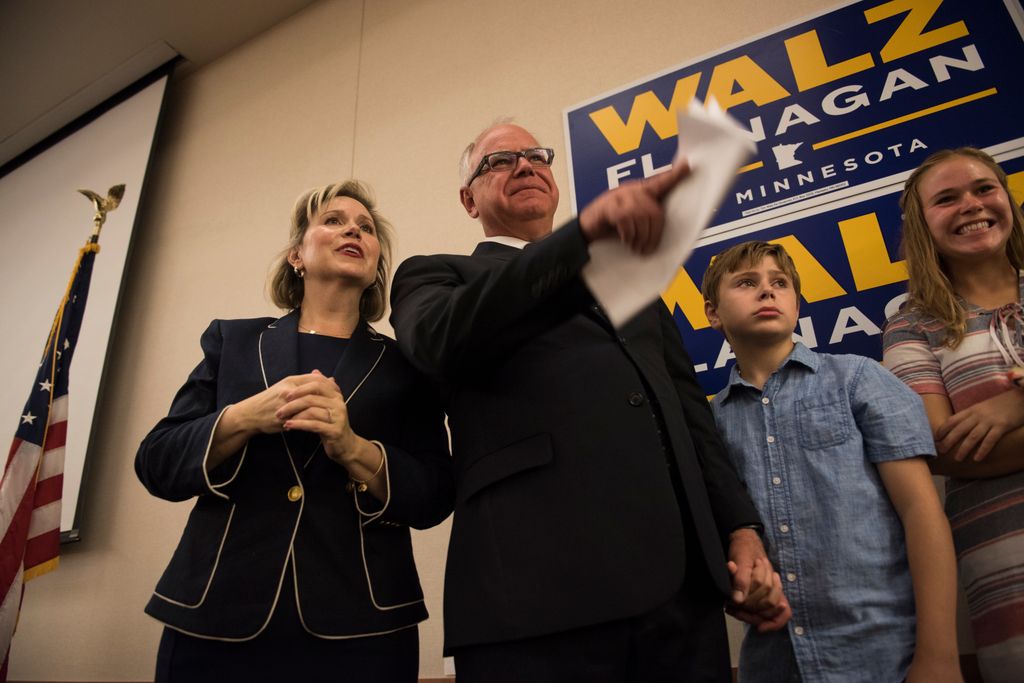 Tim Walz stands on stage at an election night party with his wife, Gwen Walz, son, Gus Walz, and daughter Hope Walz on August 14, 2018 in St Paul, Minnesota