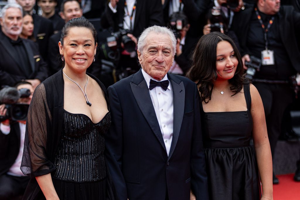 CANNES, FRANCE - MAY 13: Tiffany Chen, Robert De Niro and Helen Grace De Niro attend the red carpet for the opening ceremony and 'Partir Un Jour' (Leave One Day) screening at the 78th annual Cannes Film Festival at on May 13, 2025 in Cannes, France. (Photo by Victor LOCHON/Gamma-Rapho via Getty Images)