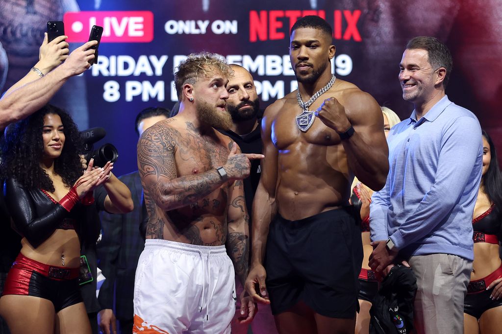 Jake Paul faces off against Anthony Joshua during the weigh-in at The Fillmore Miami Beach 