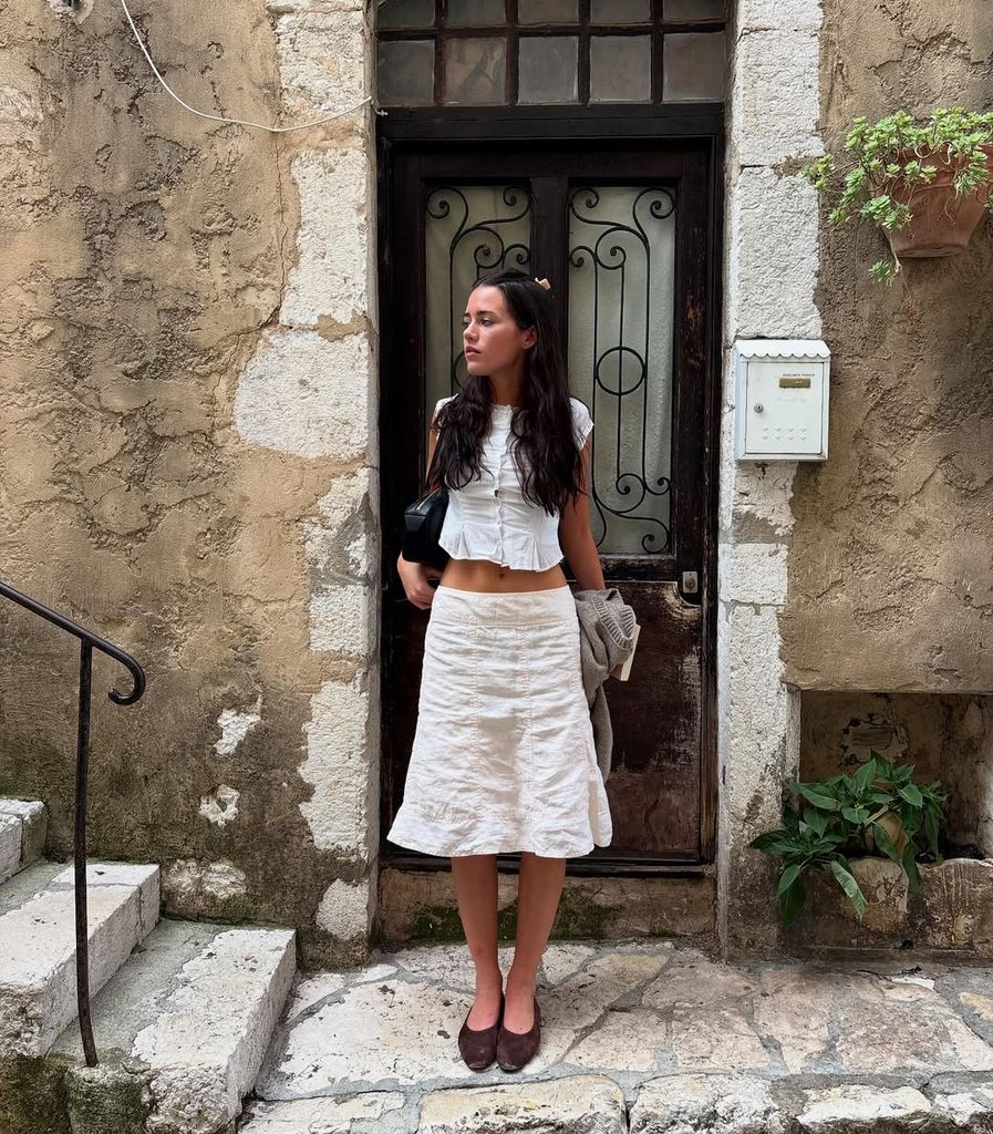 Olivia Neill in white skirt