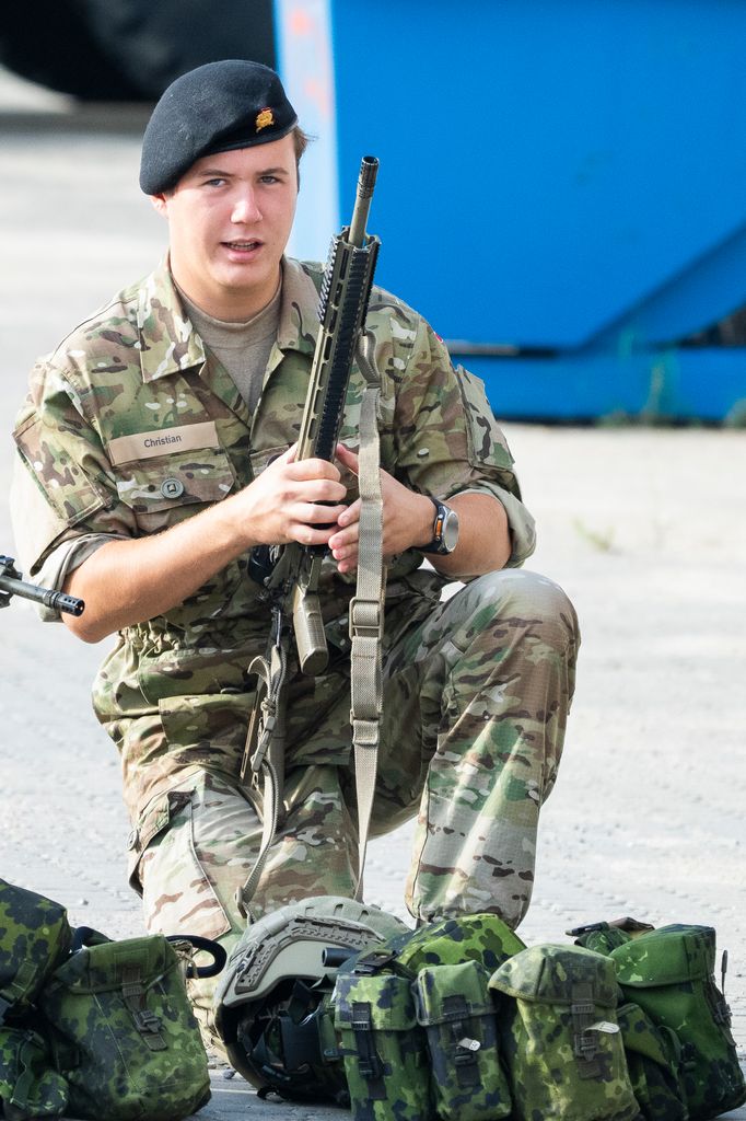 Crown Prince Christian in a military uniform with a gun