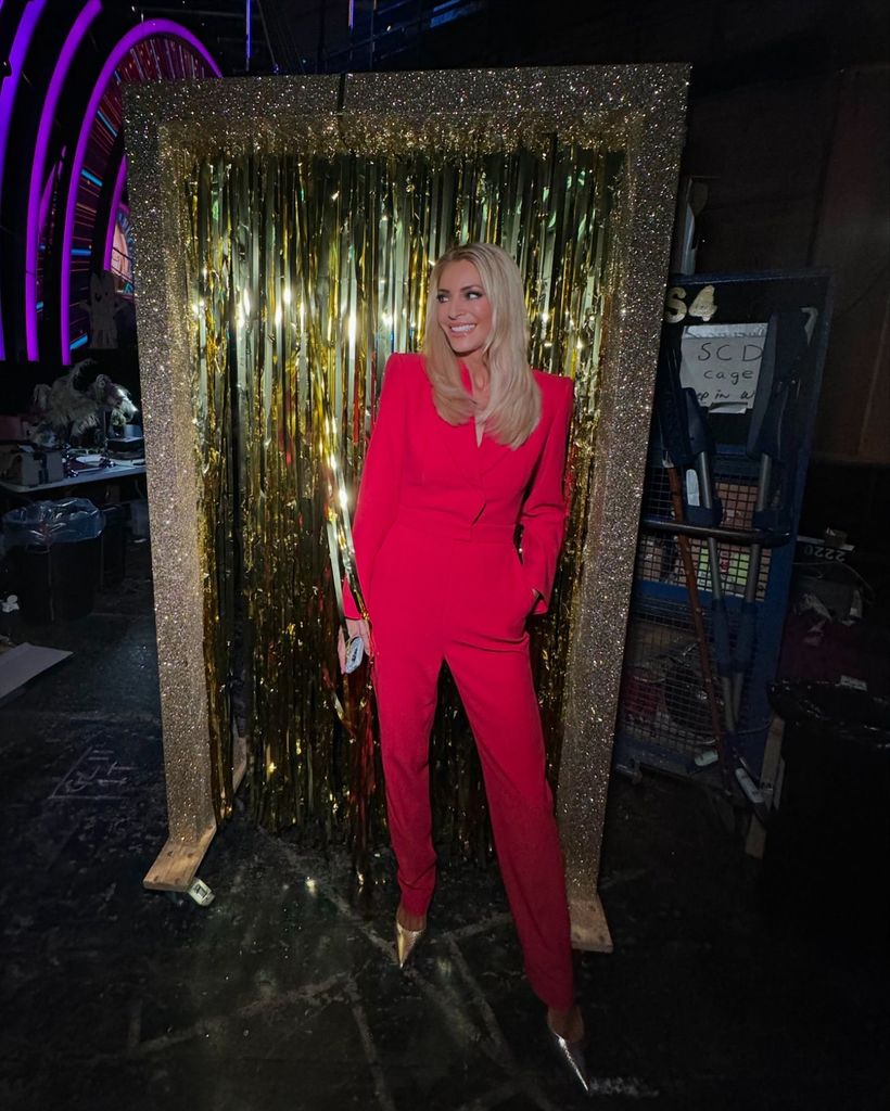 Tess daly posed in red suit