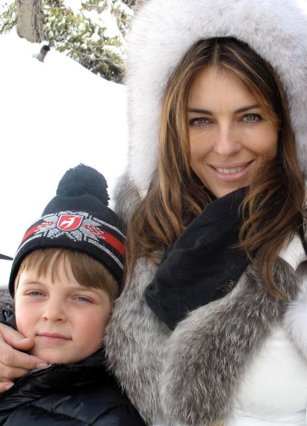 Elizabeth Hurley and young boy in the snow