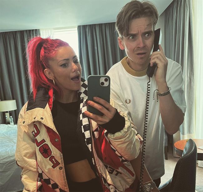 Dianne Buswell and Joe Sugg holding telephones