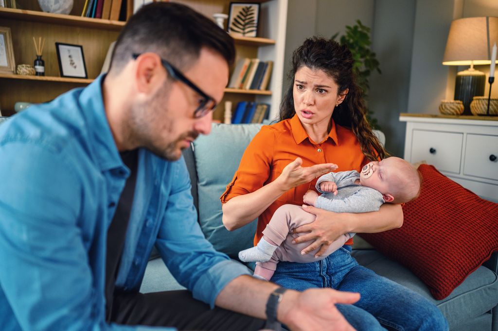 new parents with baby arguing.