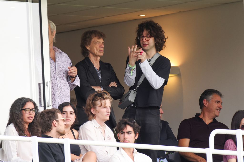 Mick Jagger and Lucas Jagger watch the cricket 