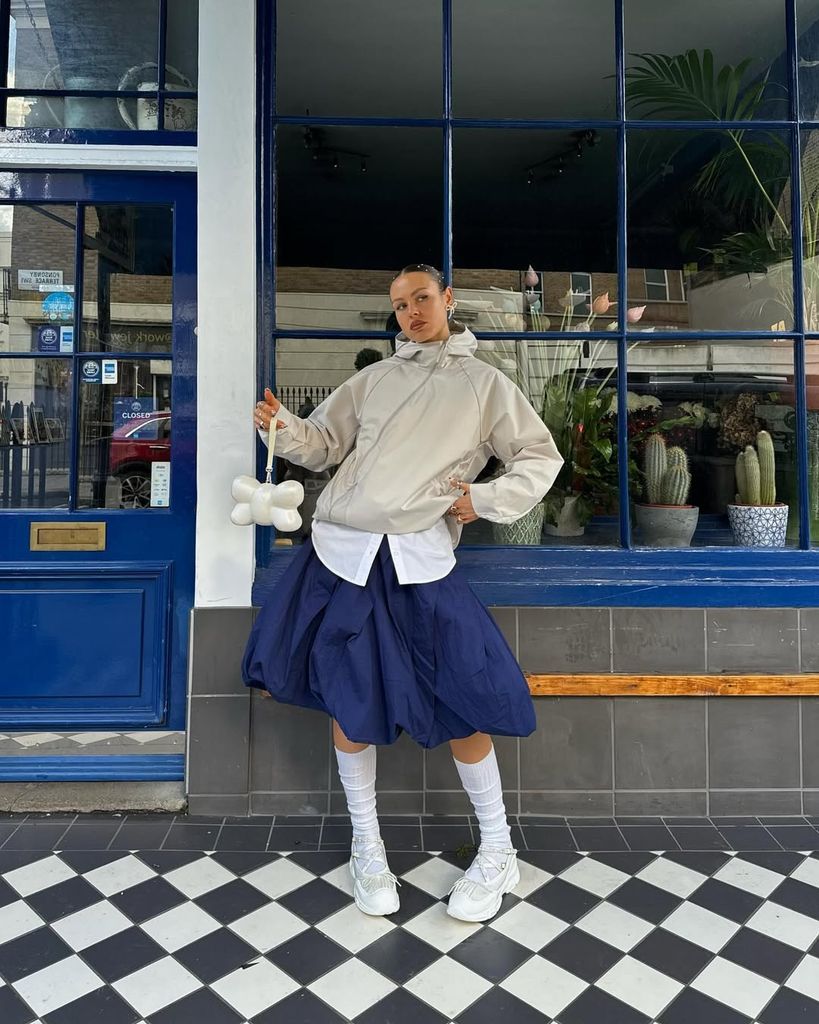 Olivia Hirst in bubble skirt and waterproof jacket