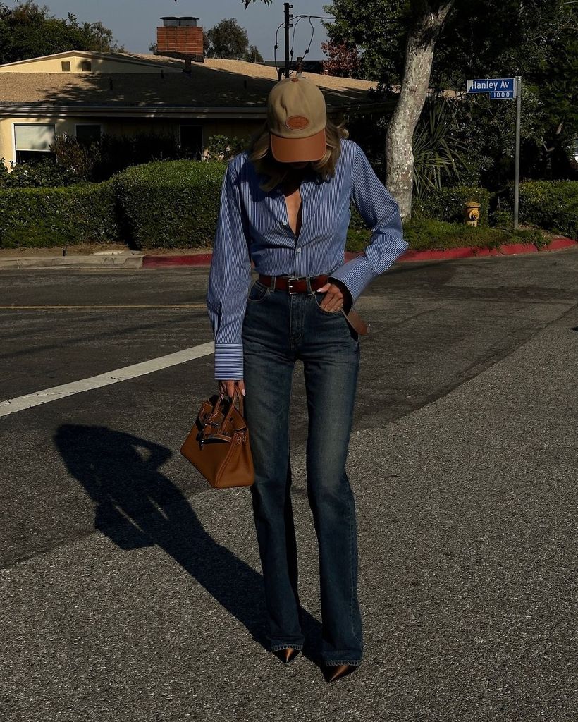 The Swedish model paired some YSL dark wash bootlegs with a striped shirt from her brand Helsa