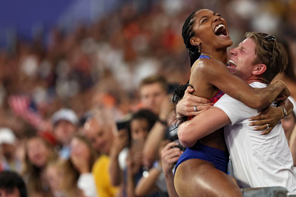 Tara Davis-Woodhall of Team United States celebrates with her husband Hunter Woodhall after winning the gold medal in the Women's Long Jump Final