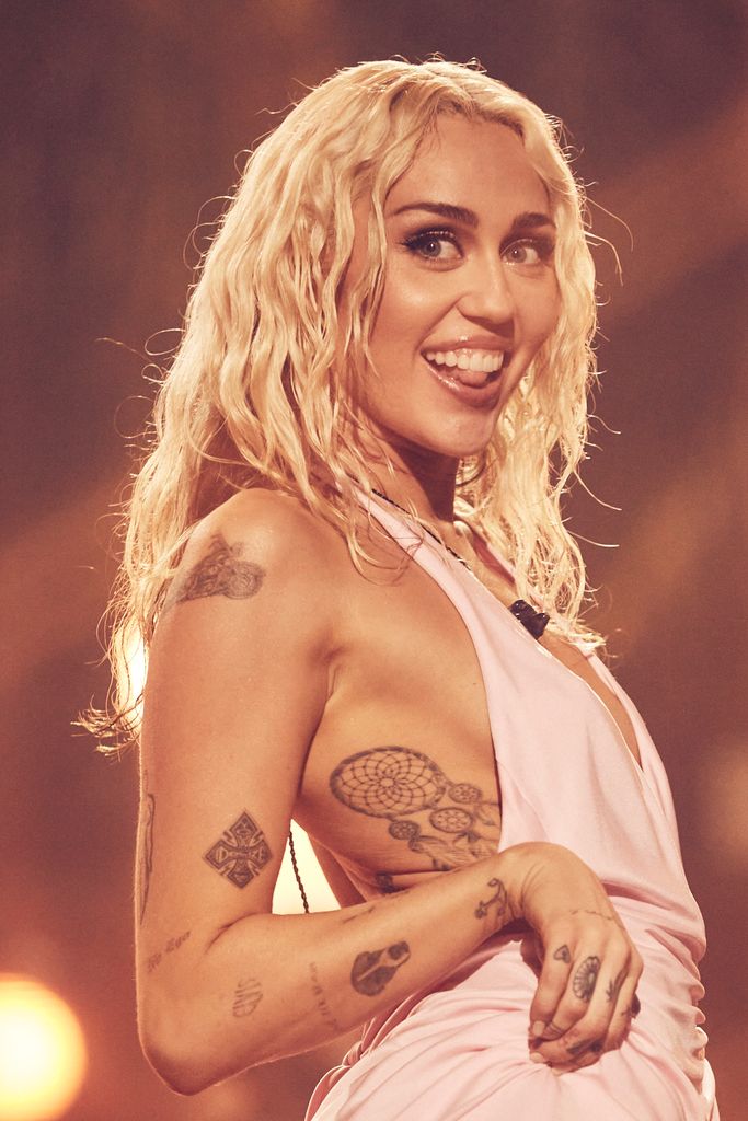 Miley Cyrus smiles on stage during New Years Eve performance
