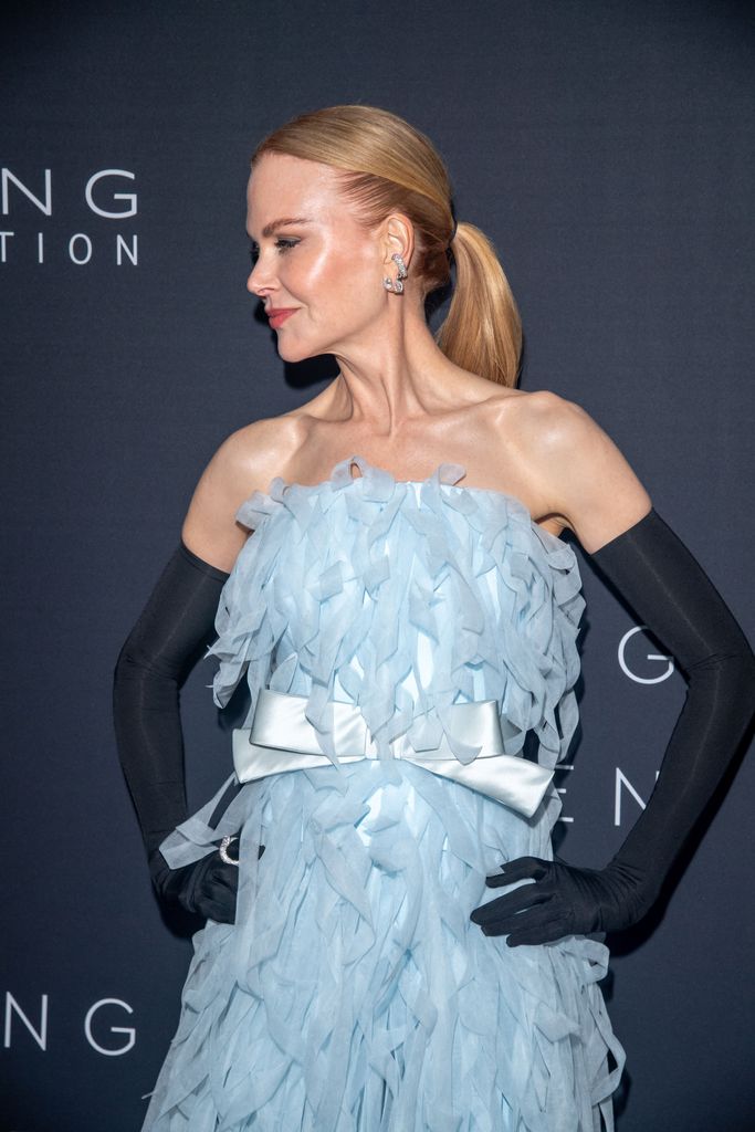 Nicole Kidman looking to the side in a blue dress