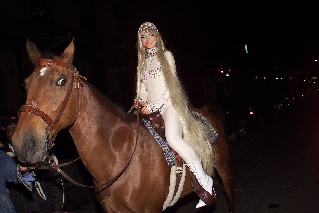 Heidi Klum riding a horse dressed as Lady Godiva 