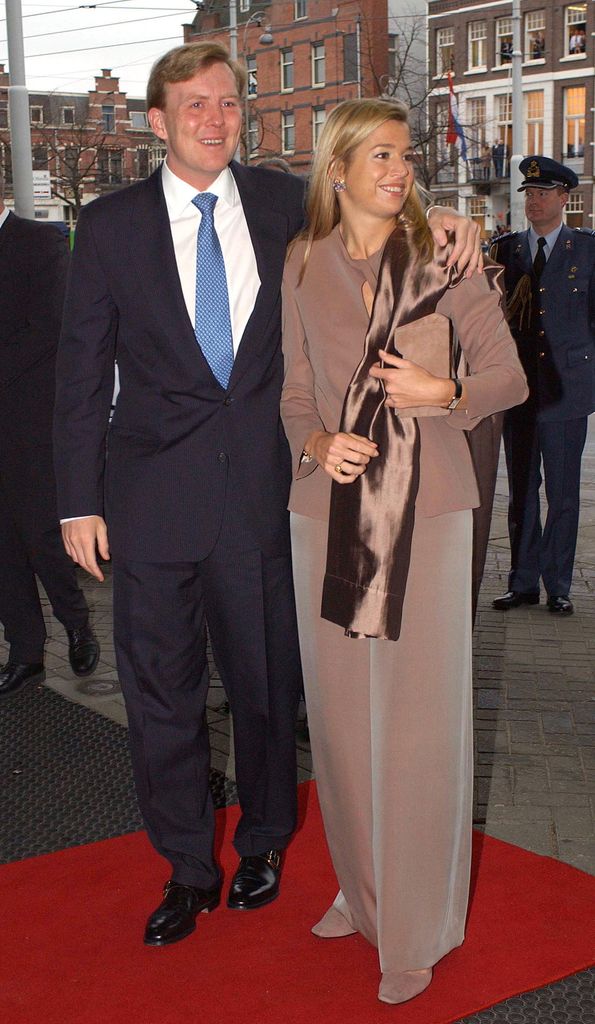 Prince Willem-Alexander in a suit with his arm around Maxima 