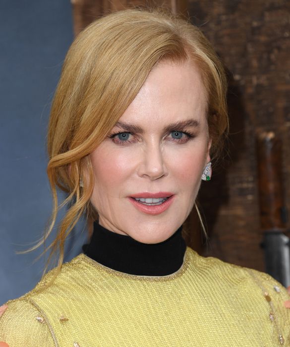 nicole kidman looking serious in a high necked green dress