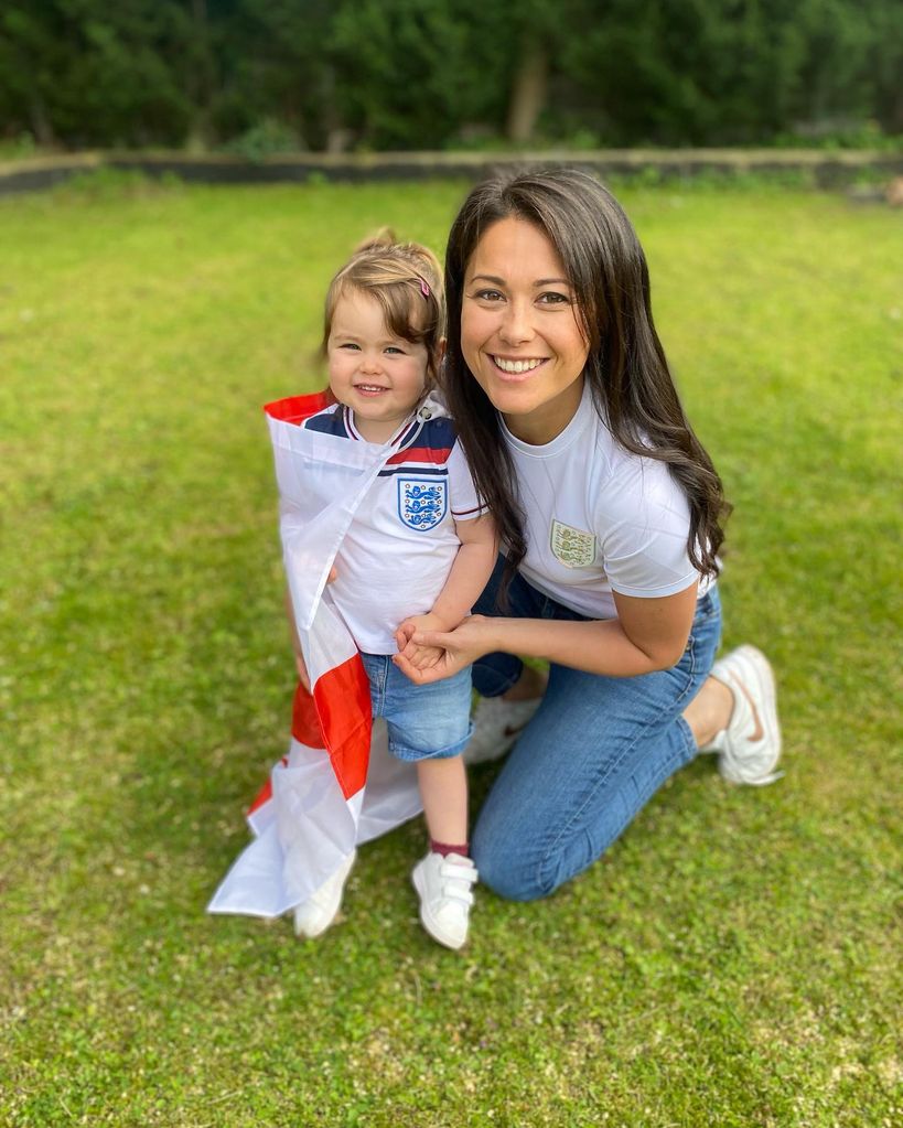 sam quek smiling with daughter