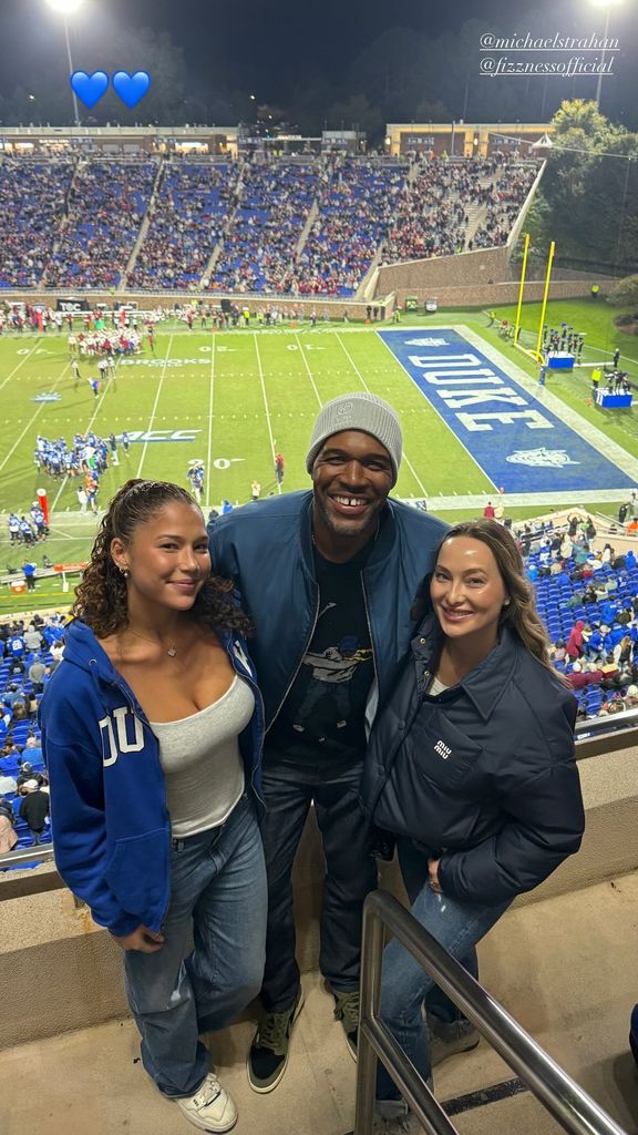 Michael Strahan flanked by his daughter Sophia Strahan and girlfriend Kayla Quick at a Duke University football game, posted on Instagram