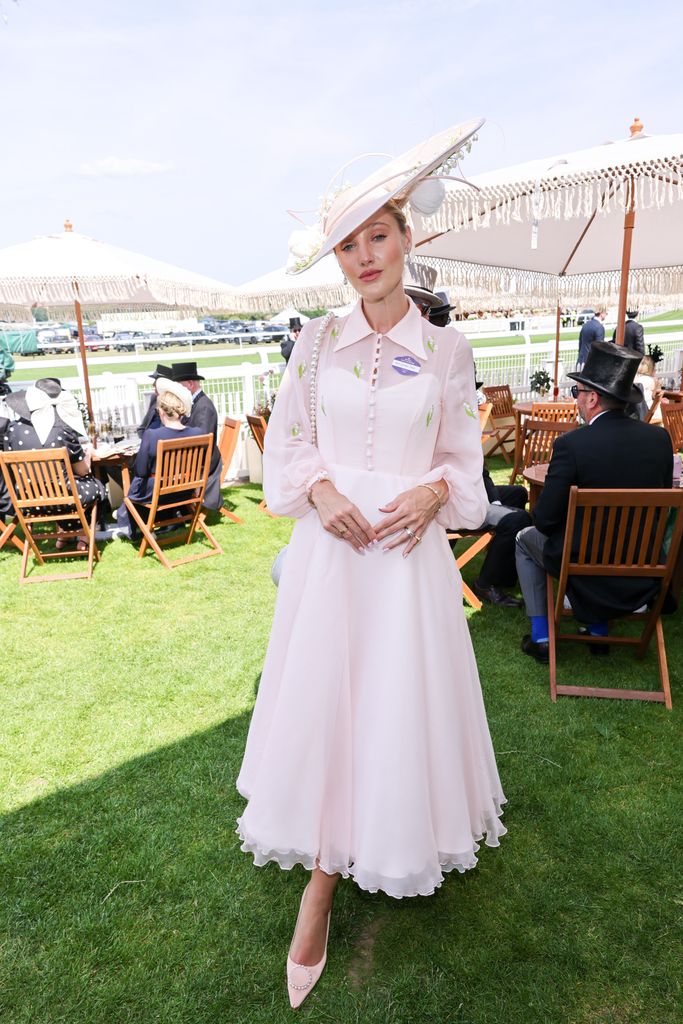 Leonora Smee wears a flowing blush pink organza dress with green floral embroidery and a wide-brim hat at Royal Ascot.
