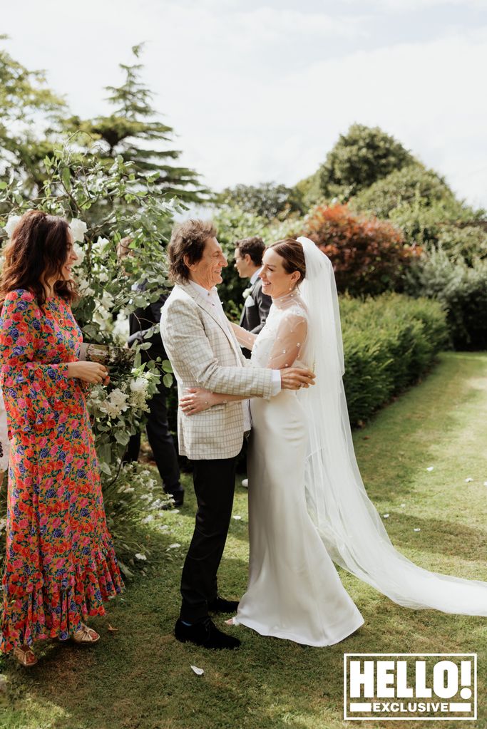 Faye Harris hugs her father-in-law Ronnie Wood in the garden