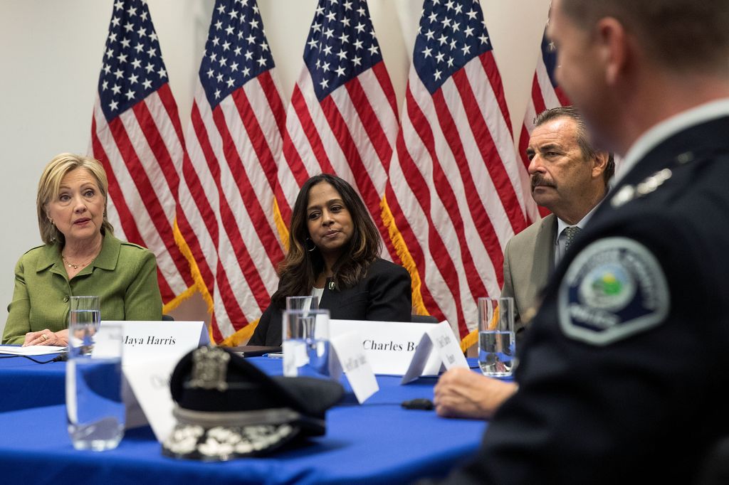 Policy advisor Maya Harris (R) looks on as then Democratic presidential candidate Hillary Clinton (L) delivers opening remarks during a meeting with law enforcement officials at the John Jay College of Criminal Justice, August 18, 2016 